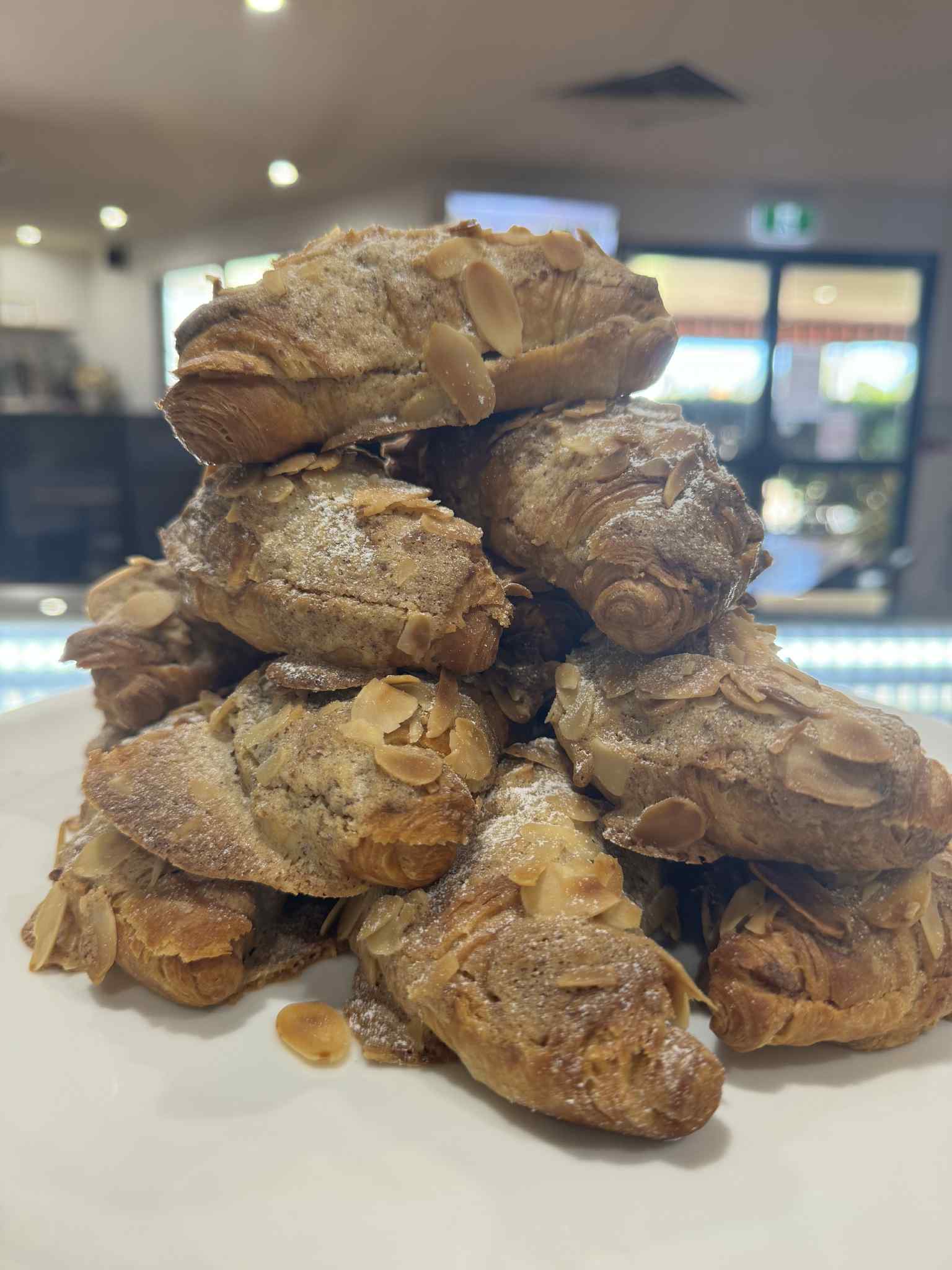 Almond croissant available at The Social Cafe in Emerald QLD 4720 – takeaway or dine-in from the cake cabinet.