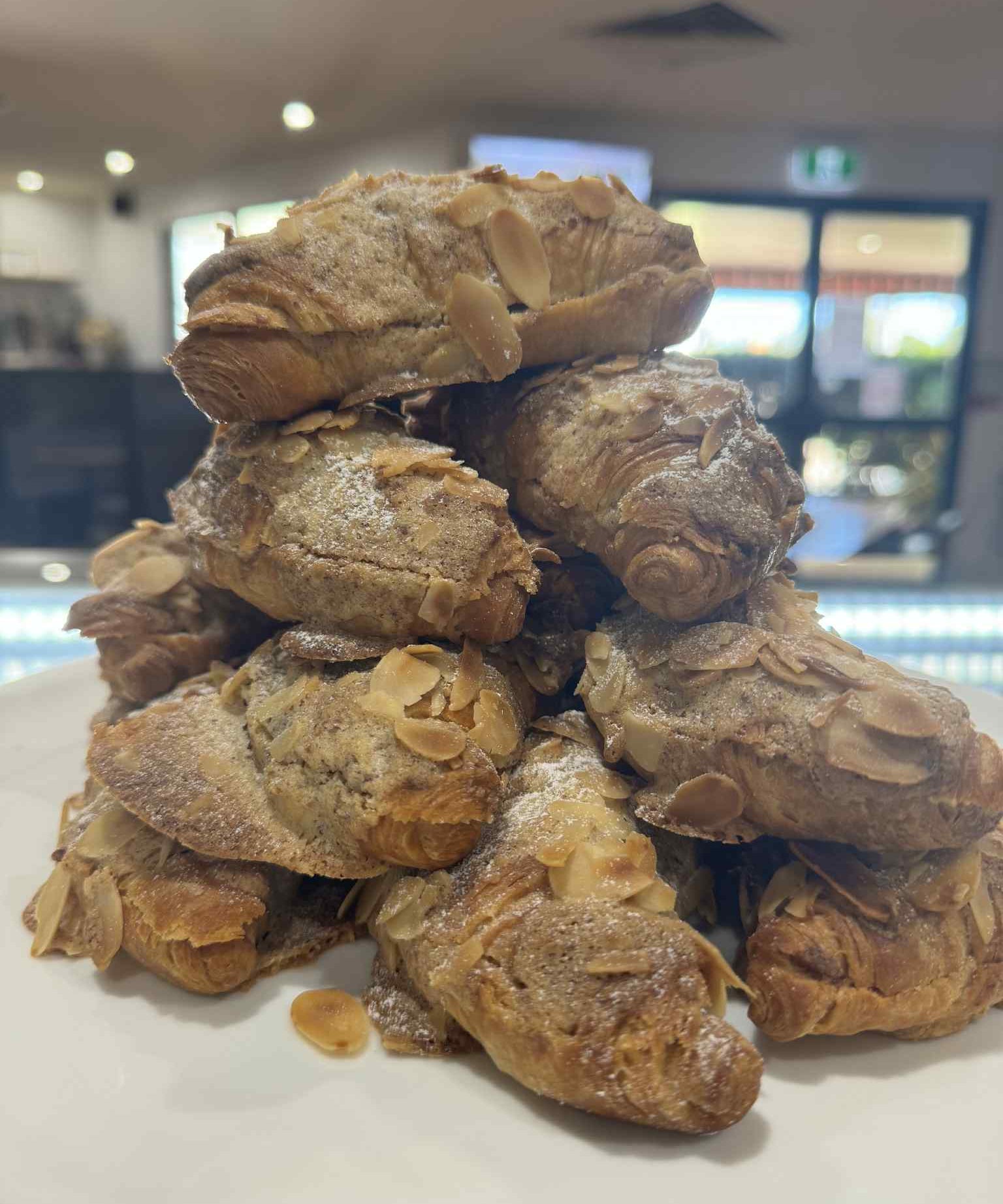 Almond croissant available at The Social Cafe in Emerald QLD 4720 – takeaway or dine-in from the cake cabinet.