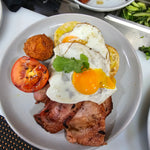 Barn Yard Breakfast with eggs, crispy bacon, grilled tomato, homemade hash brown, and toasted Turkish bread at The Social Cafe in Emerald QLD 4720.