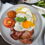 Barn Yard Breakfast with eggs, crispy bacon, grilled tomato, homemade hash brown, and toasted Turkish bread at The Social Cafe in Emerald QLD 4720.