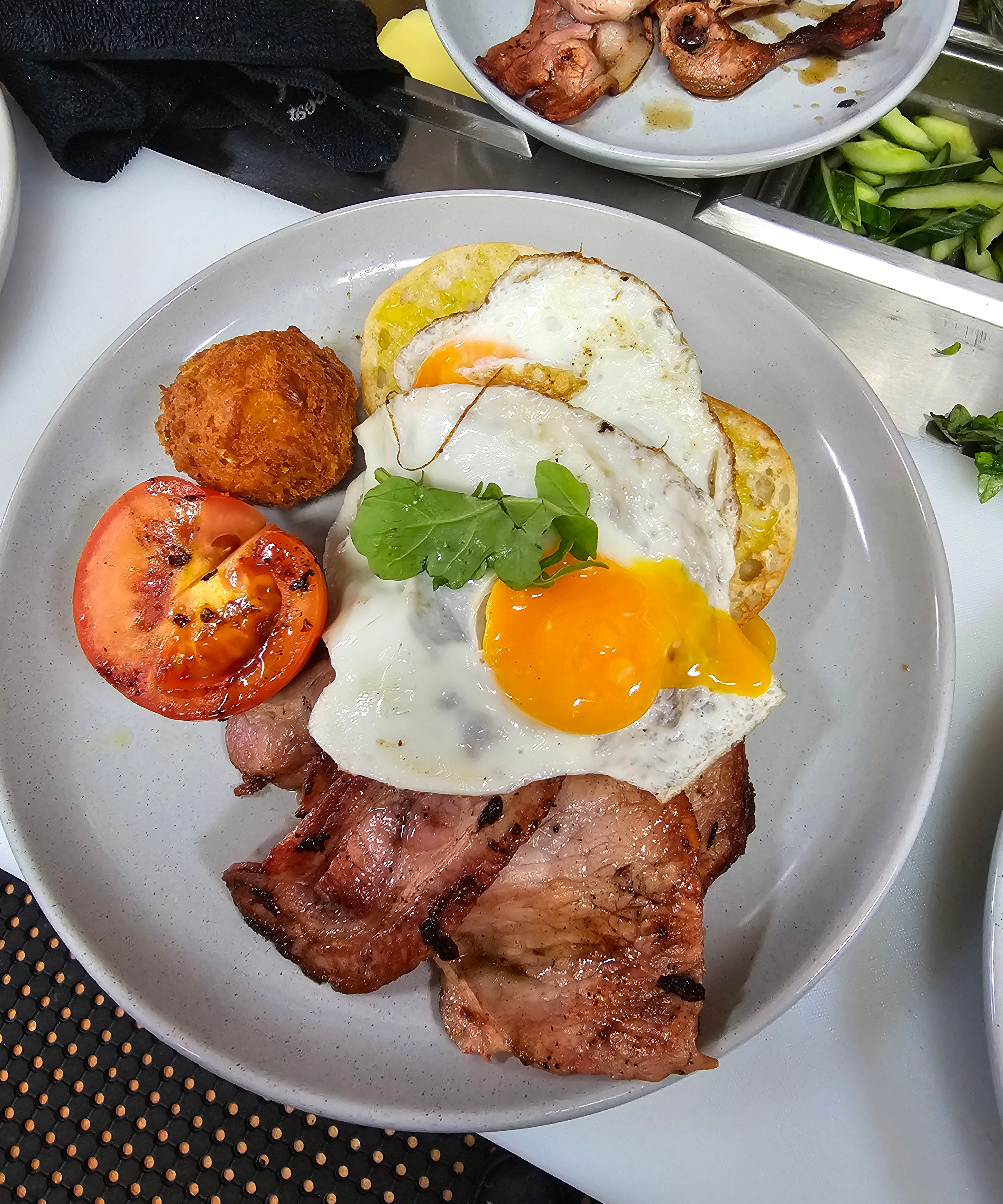 Barn Yard Breakfast with eggs, crispy bacon, grilled tomato, homemade hash brown, and toasted Turkish bread at The Social Cafe in Emerald QLD 4720.
