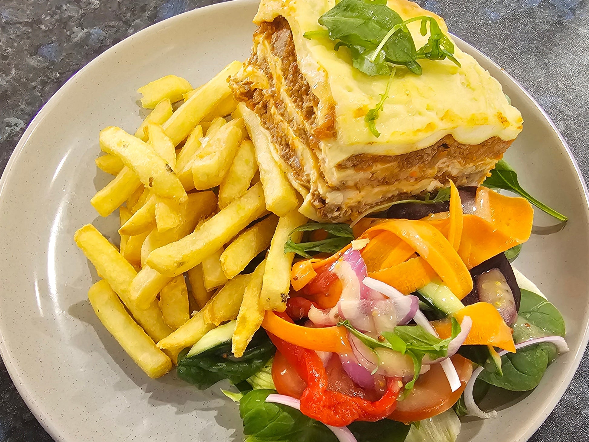 Beef lasagna served with chips and fresh salad from The Social Cafe in Emerald QLD 4720 – available for catering and takeaway.