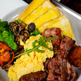 Bruce Almighty breakfast plate with bacon, eggs, chipolatas, hash brown, grilled mushrooms, spinach, grilled tomato, and toast at The Social Cafe in Emerald QLD 4720.