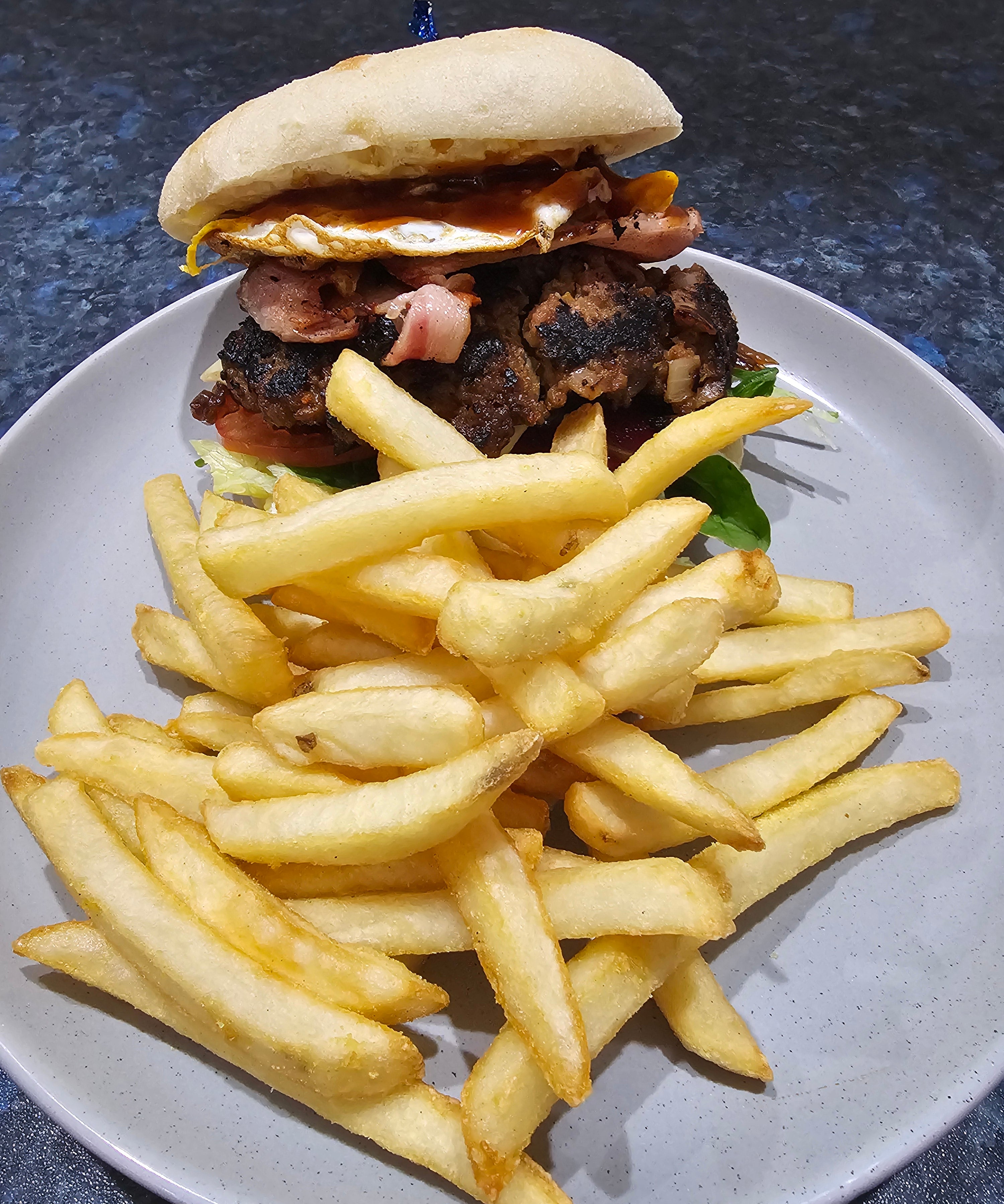 Burger Hill loaded beef burger with bacon, egg, cheese, vegetables, and chips from The Social Cafe in Emerald QLD 4720.