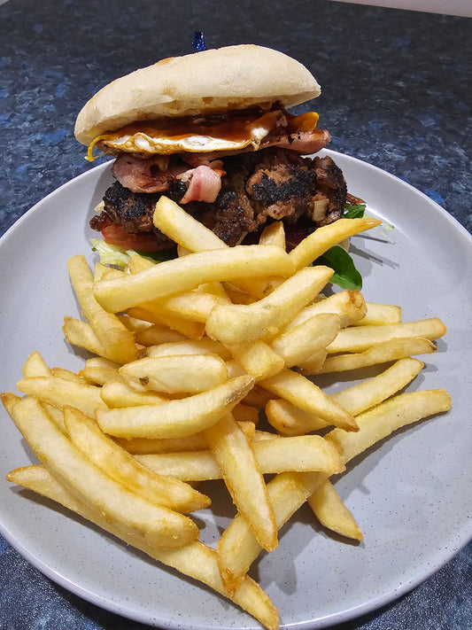 Burger Hill loaded beef burger with bacon, egg, cheese, vegetables, and chips from The Social Cafe in Emerald QLD 4720.