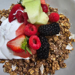 Wholesome granola with creamy coconut yogurt, fresh seasonal fruits, and berry coulis from The Social Cafe in Emerald QLD 4720.