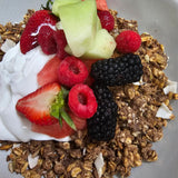 Wholesome granola with creamy coconut yogurt, fresh seasonal fruits, and berry coulis from The Social Cafe in Emerald QLD 4720.