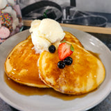 Trio of fluffy pancakes with maple syrup and ice cream from The Social Cafe in Emerald QLD 4720.