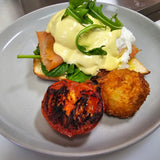 Terry Benedict with poached eggs, spinach, toasted Turkish bread, choice of bacon, ham, pulled pork, smoked salmon, or halloumi, grilled tomato, and homemade hash brown at The Social Cafe in Emerald QLD 4720.