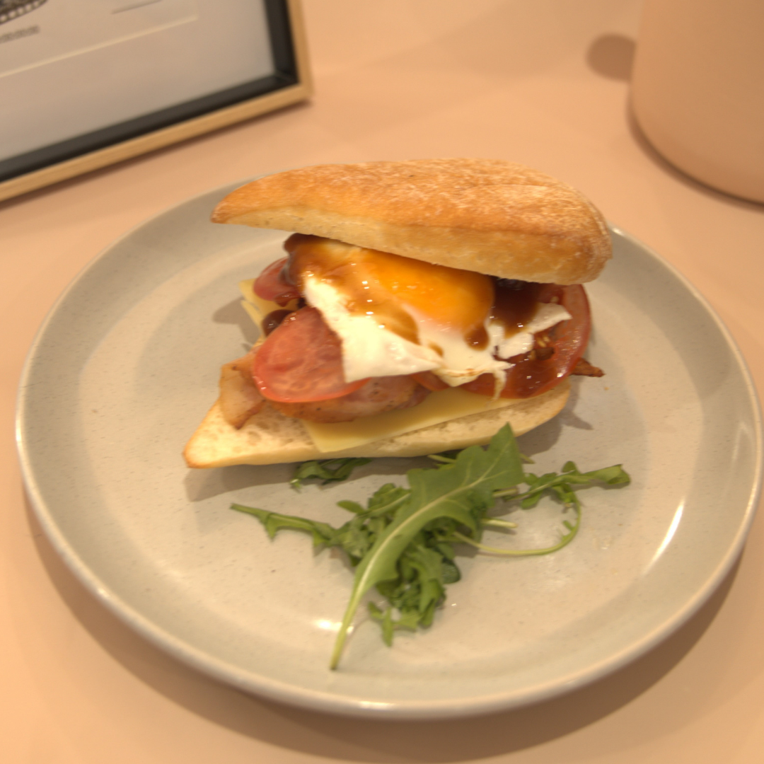 Bacon, egg, and cheese sandwich with tomato and BBQ sauce from The Social Cafe in Emerald QLD 4720.